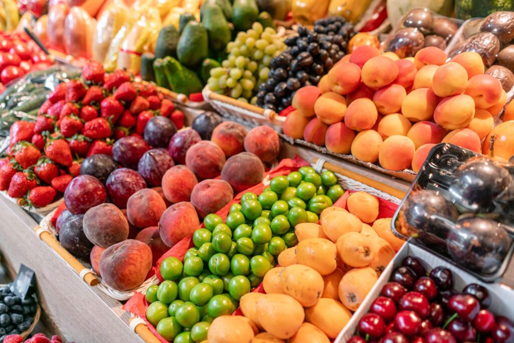 Bins of various fruits at a farmers market