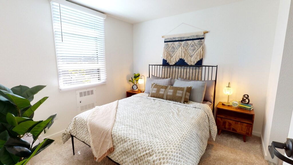 Bed, under-bed dressers, and nightstands in furnished Telegraph Gardens apartment. 