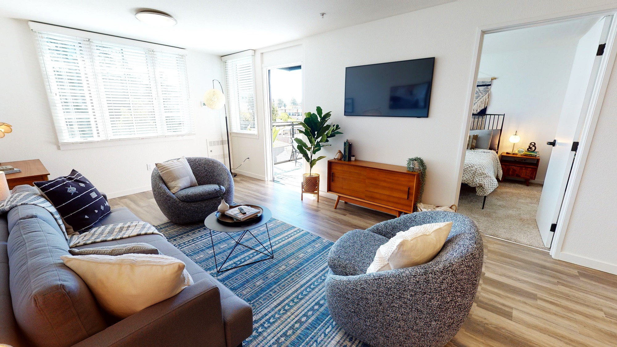 Furnished living room, bedroom, and patio at Telegraph Gardens in Berkeley, California.